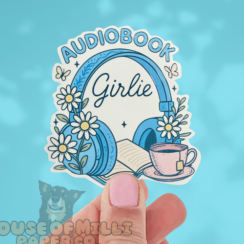 Sticker with 'AUDIOBOOK Girlie' design featuring headphones, flowers, and a teacup on a blue background.