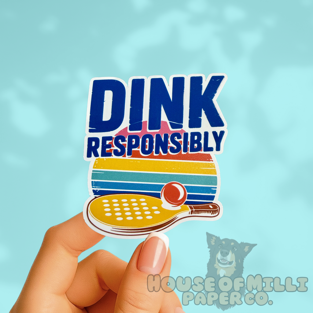 Sticker with 'Dink Responsibly' text held by a hand against a light blue background.