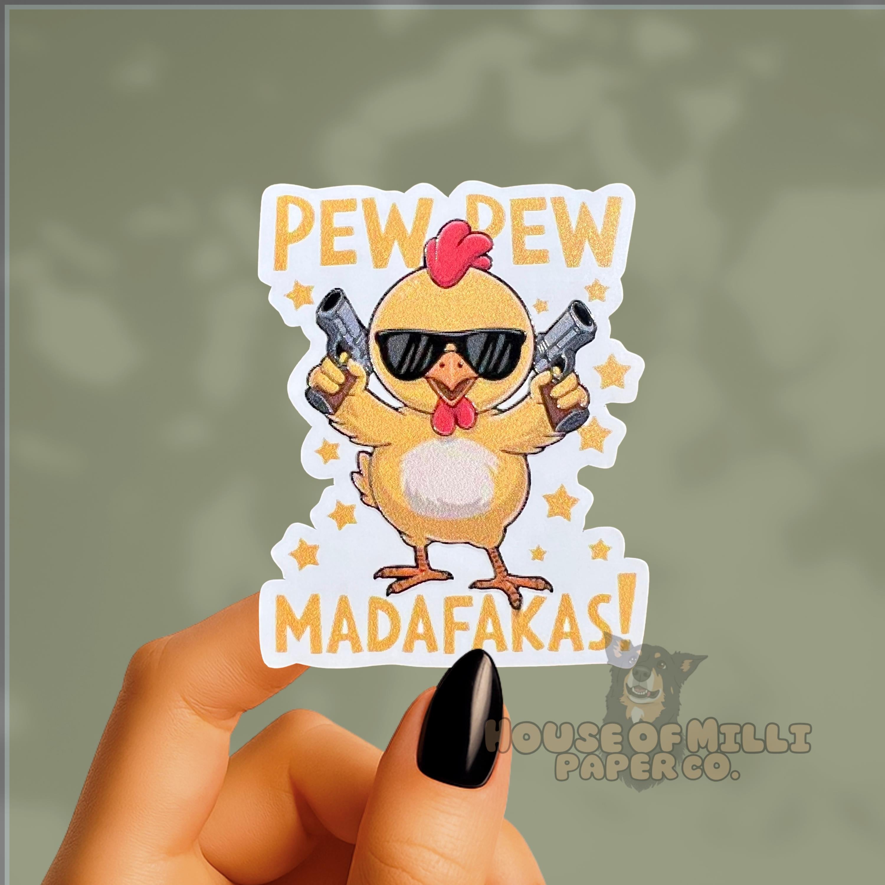 Sticker with a chicken holding guns and text 'Pew Pew Madafakas!' held by a hand.