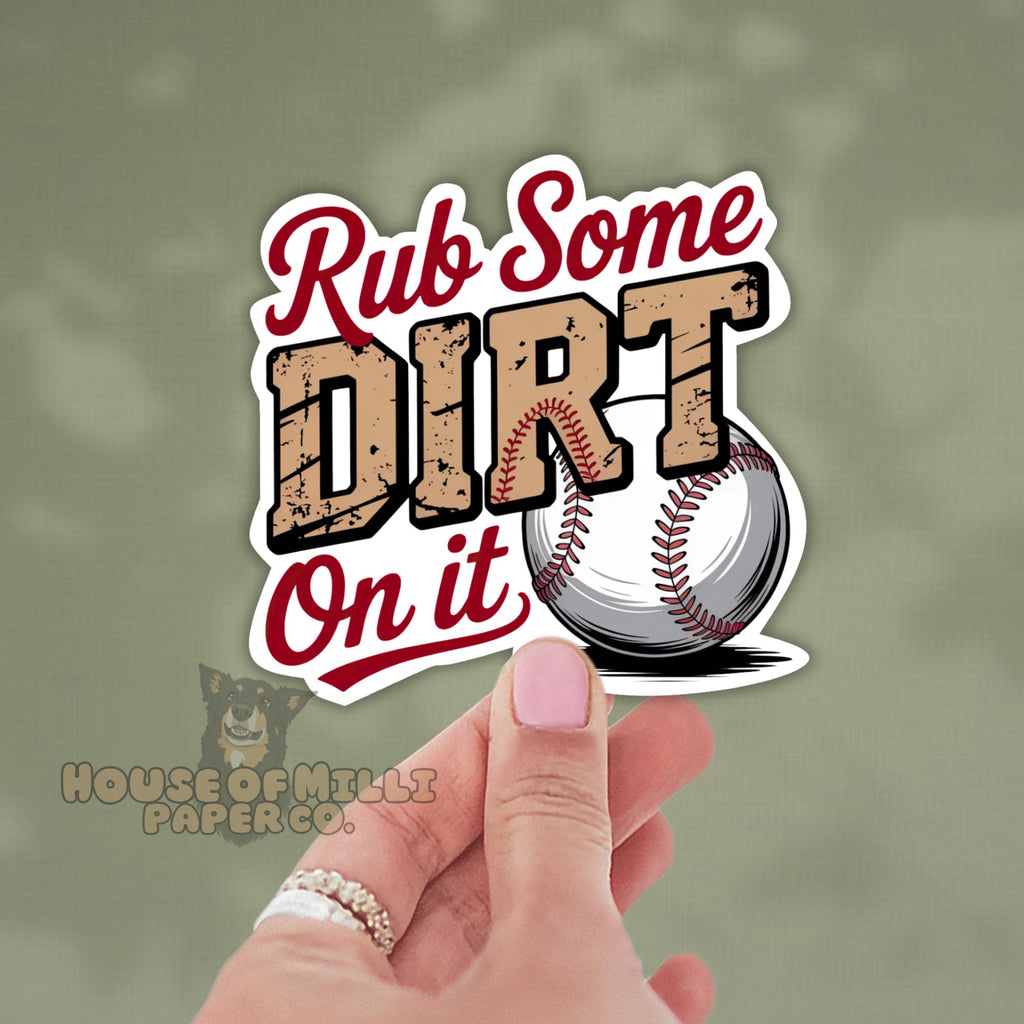 Sticker with 'Rub Some Dirt On It' text and a baseball held by a hand against a green background.
